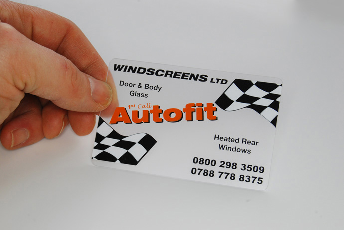 a frosted plastic card printed with black, white and orange ink