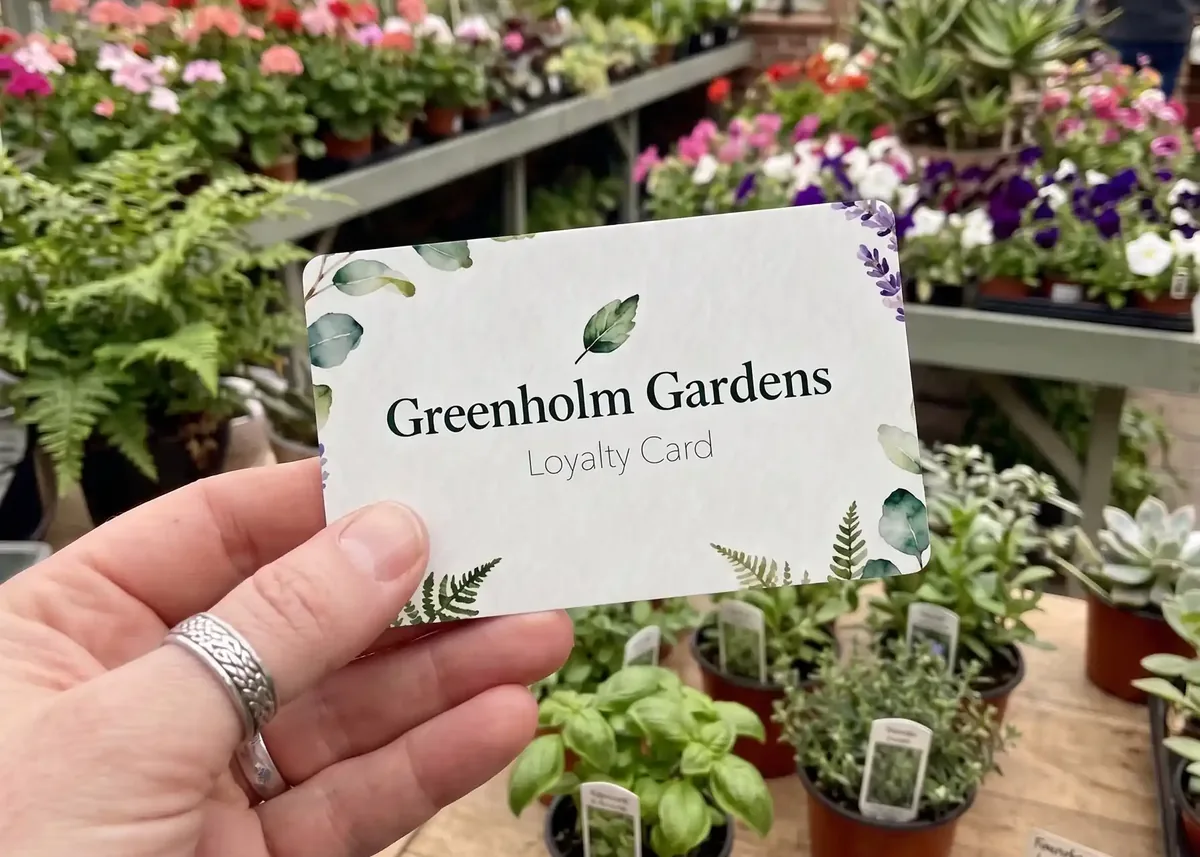 Greenholm Gardens loyalty card held in a garden centre
