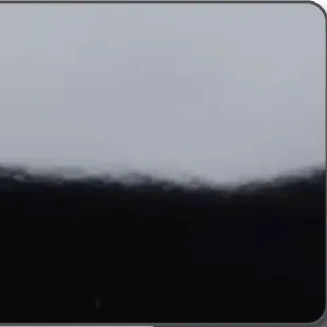 close-up of a black plastic card with a High Gloss finish, its mirror-like surface reflecting the light above it