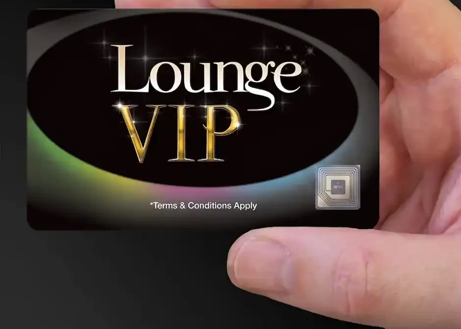 a hand holding a black Lounge VIP card with a small RFID symbol in the corner