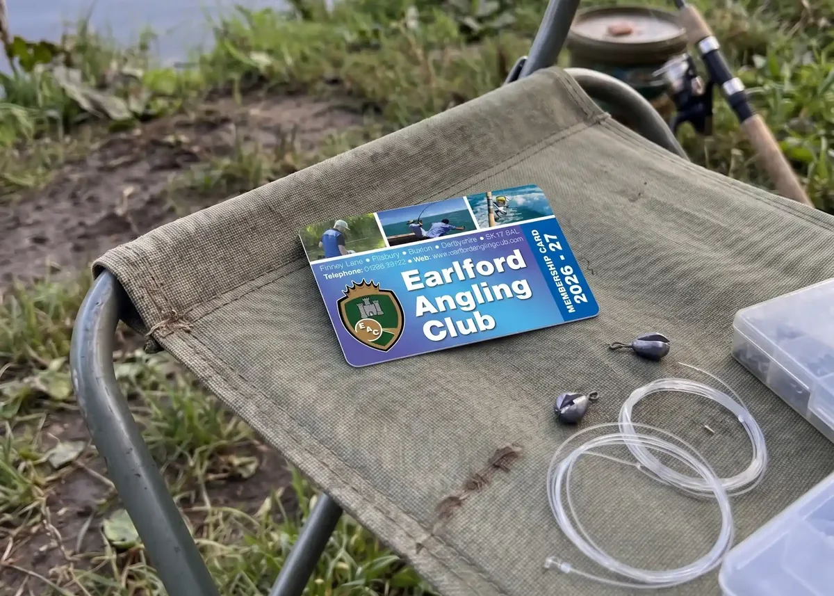 Earlford Angling Club membership card on a fishing chair with tackle