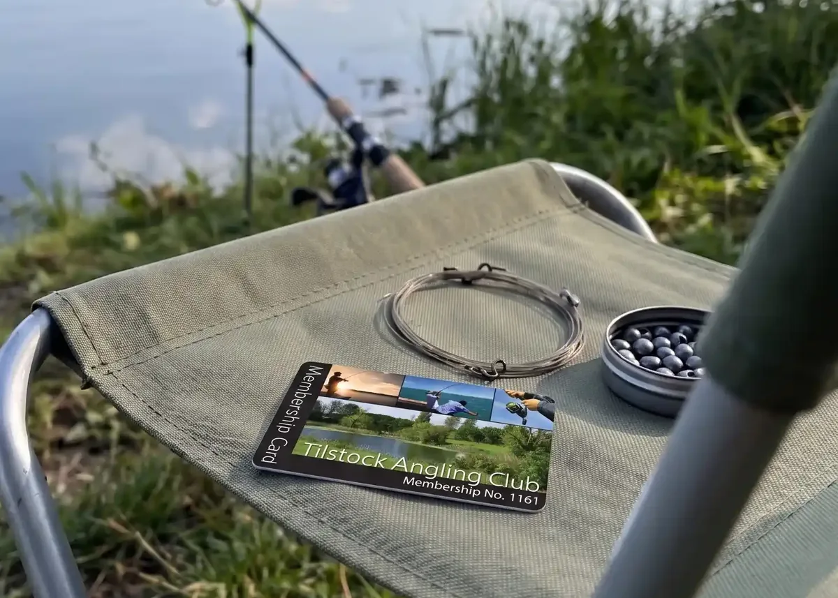 Tilstock Angling Club membership card on a bankside chair