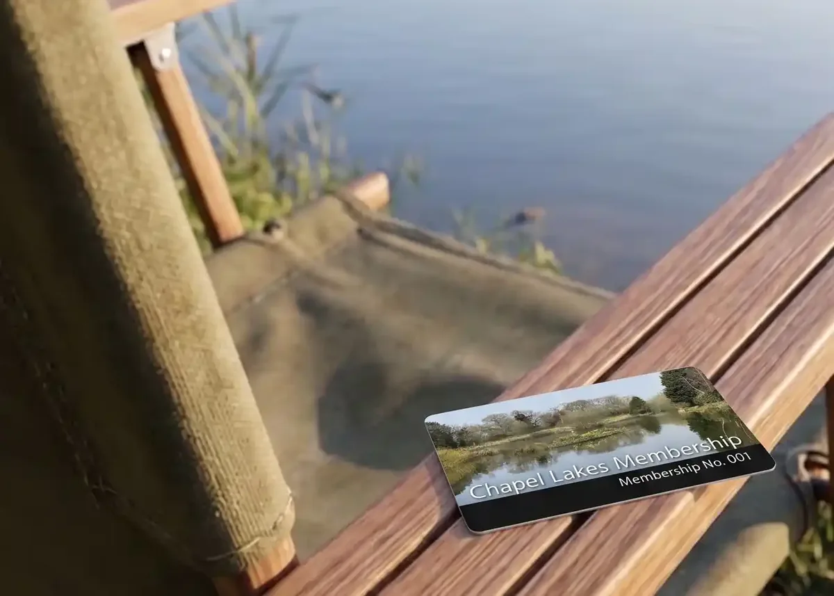 Glen Farm membership card on the arm of a lakeside chair