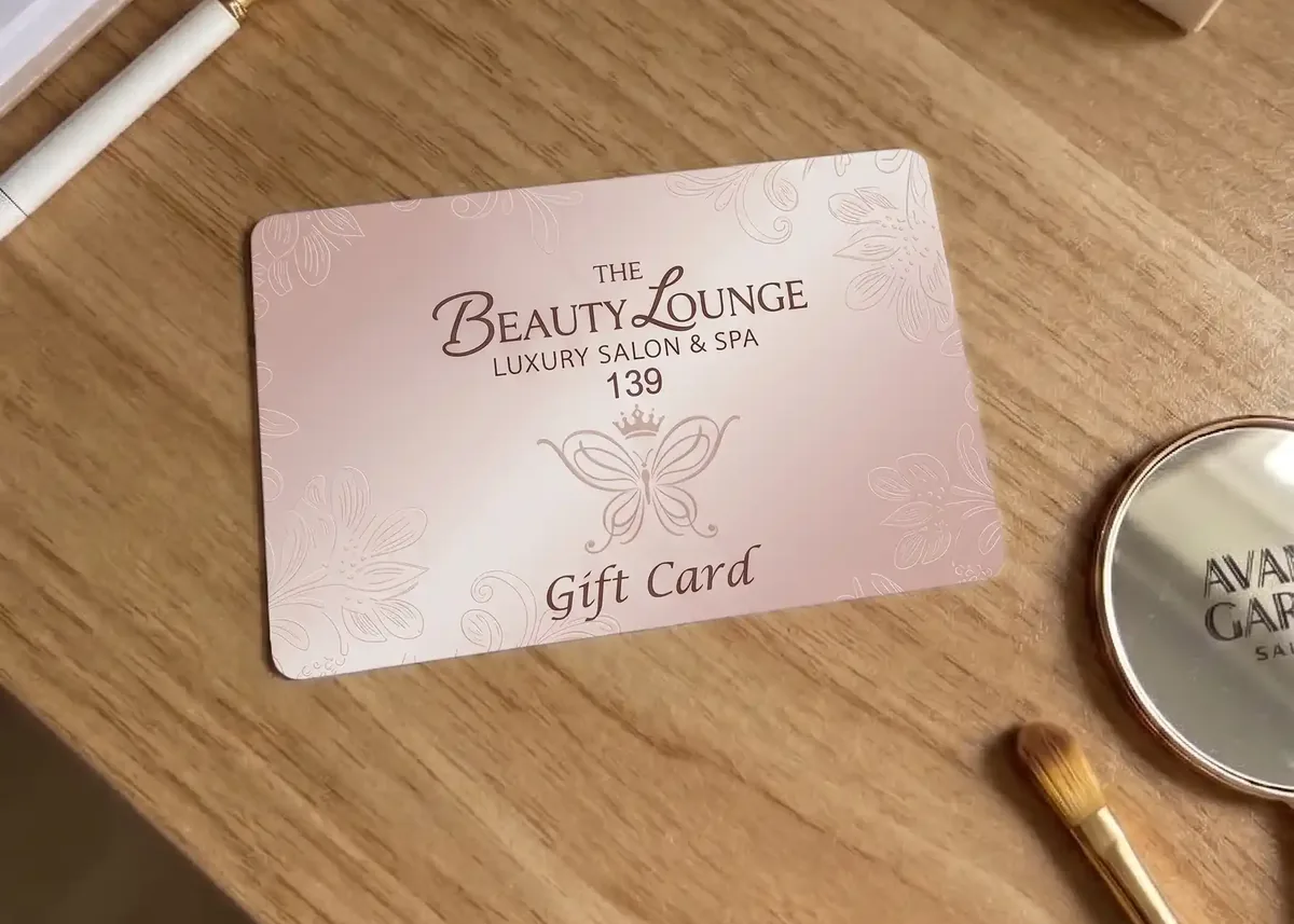 The Beauty Lounge salon and spa gift card on a wooden table