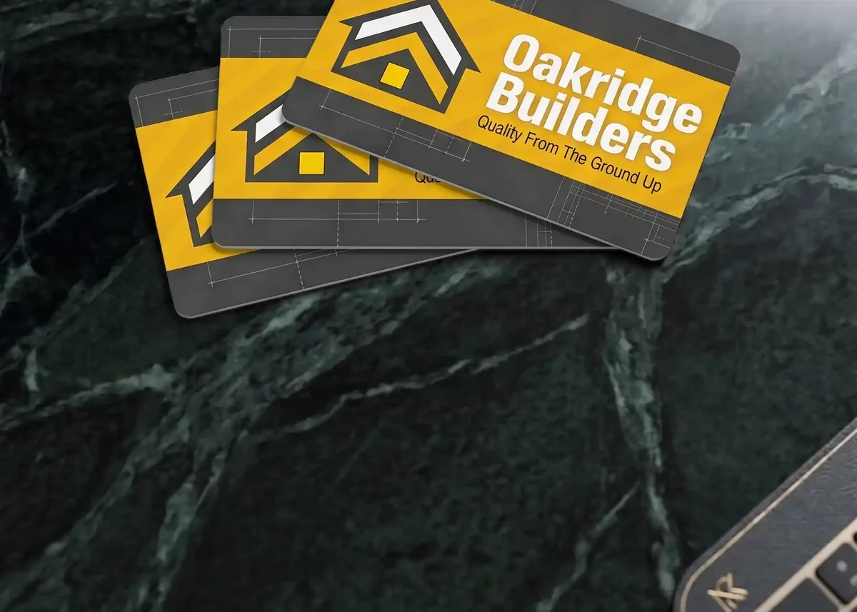 Oakridge Builders plastic business cards on a marble surface