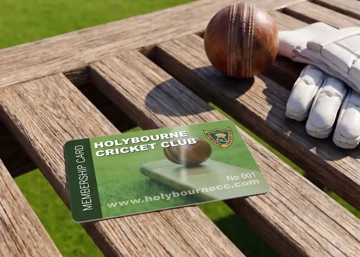 Holybourne Cricket Club membership card on a bench beside batting gloves