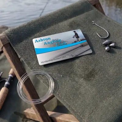 Ashton Angling Club membership card with hook and weights on a fishing chair