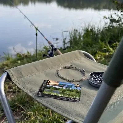 Tilstock Angling Club membership card on a bankside chair