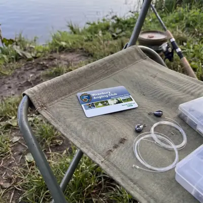 Angling club membership card with club logo on a fishing chair