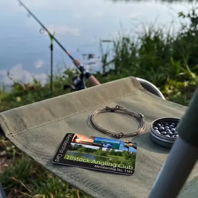 Tilstock Angling Club membership card on a bankside fishing chair