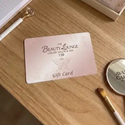 The Beauty Lounge salon and spa gift card on a wooden table