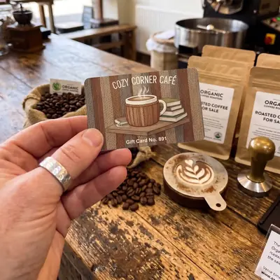 Cozy Corner Cafe gift card held in a coffee roastery