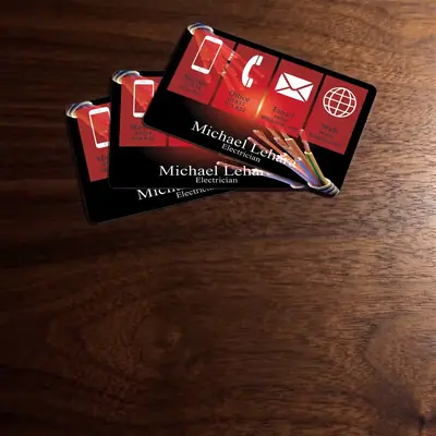 Electrician plastic business cards on a wooden desk