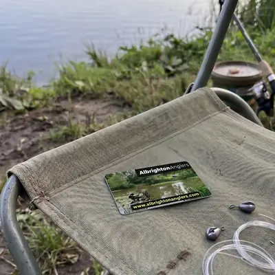 Albrighton Anglers membership card on a fishing chair by the water