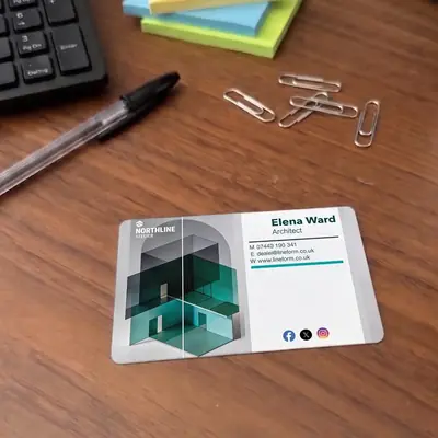 Architect plastic business card on a desk with paper clips